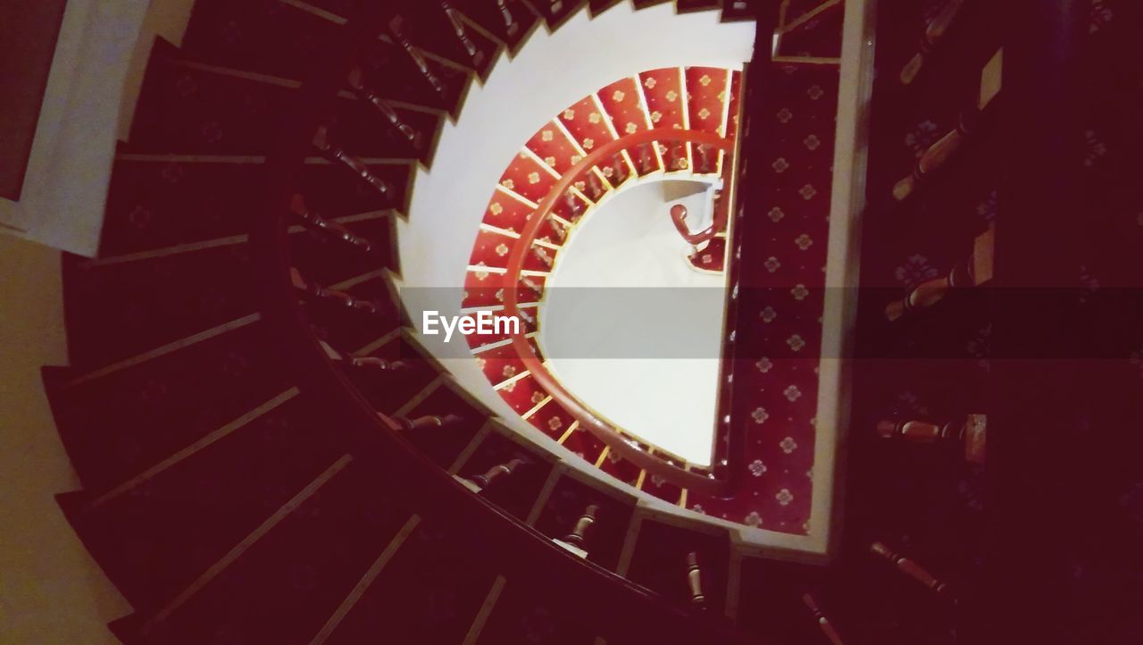 LOW ANGLE VIEW OF SPIRAL STAIRCASE IN BUILDING