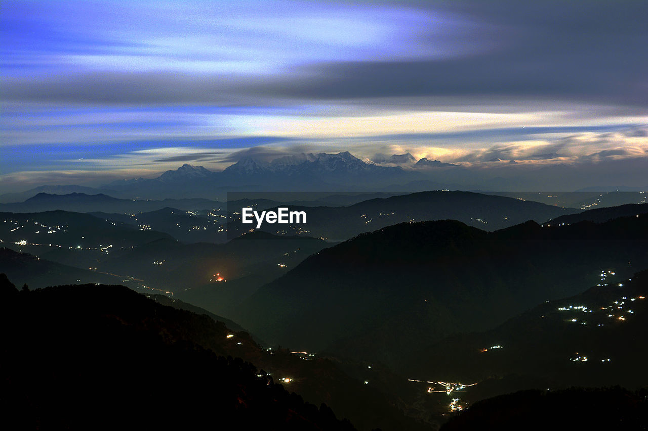 SCENIC VIEW OF MOUNTAINS AGAINST SKY AT NIGHT