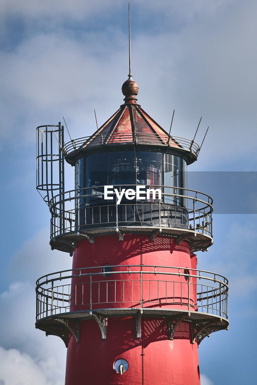 lighthouse by sea against clear sky