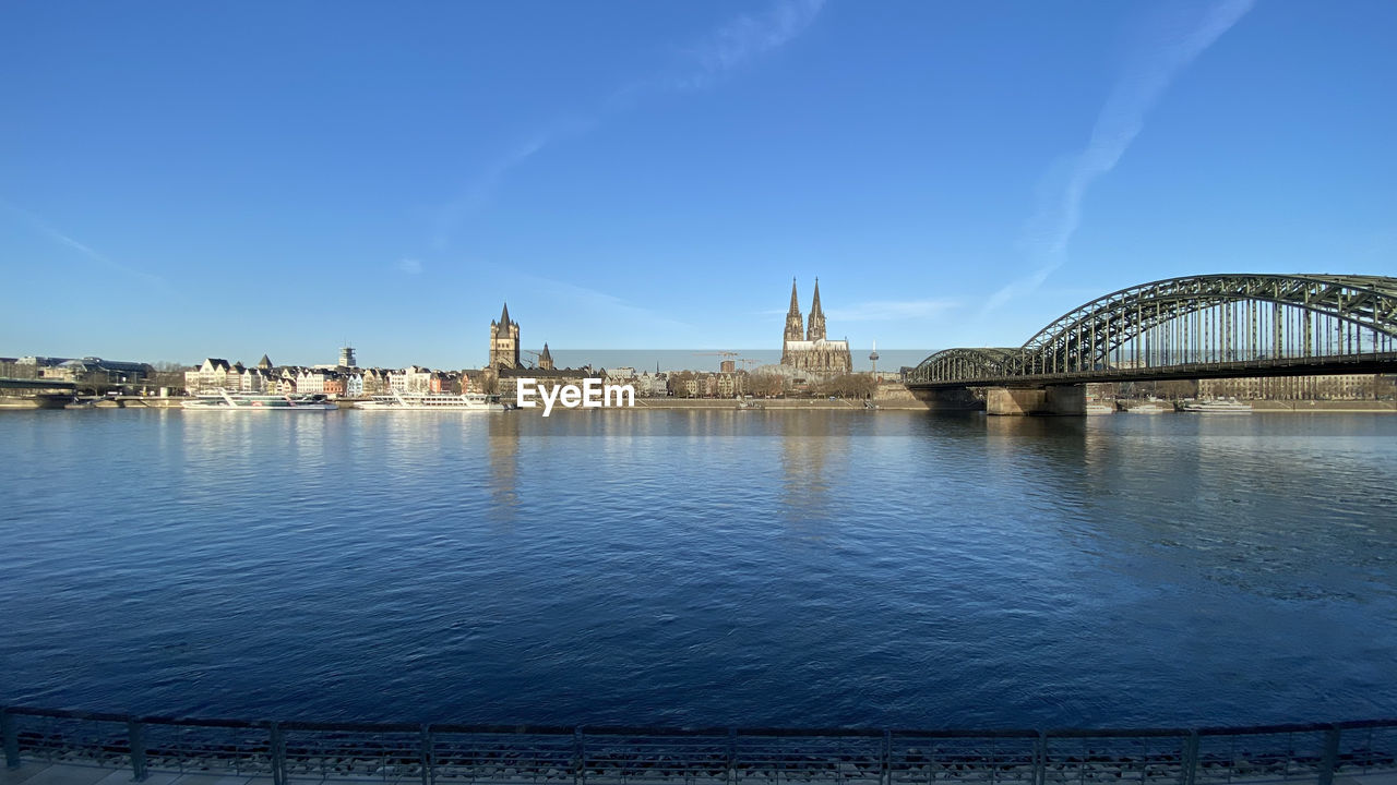 Bridge over river with buildings in background