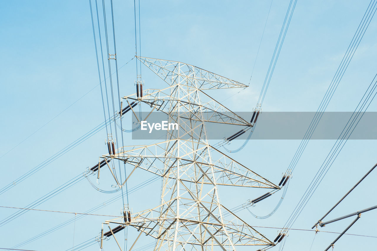 Low angle view of electricity pylon against clear sky