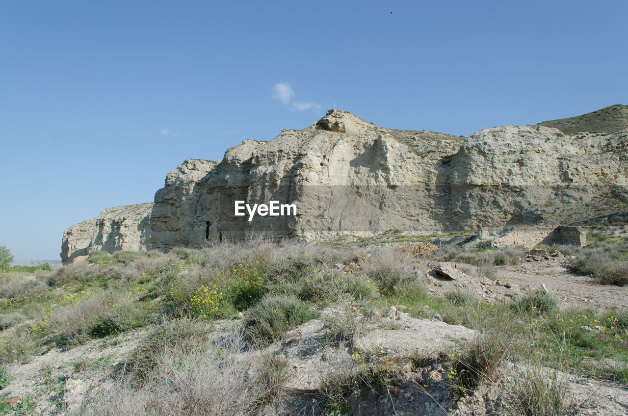 Scenic view of mountain against clear blue sky