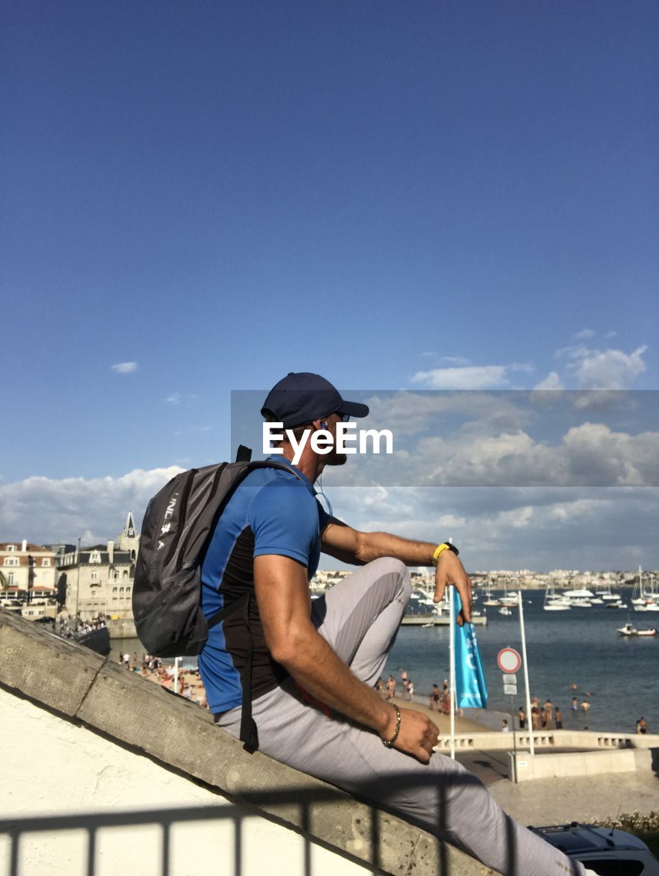 MAN SITTING ON BOAT LOOKING AT VIEW