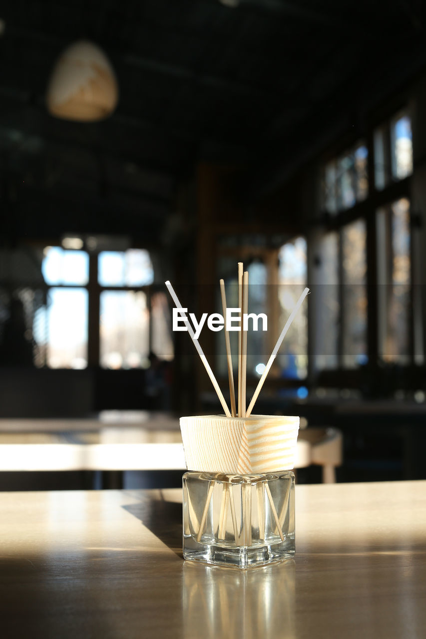 Close-up of  incense sticks on table in restaurant