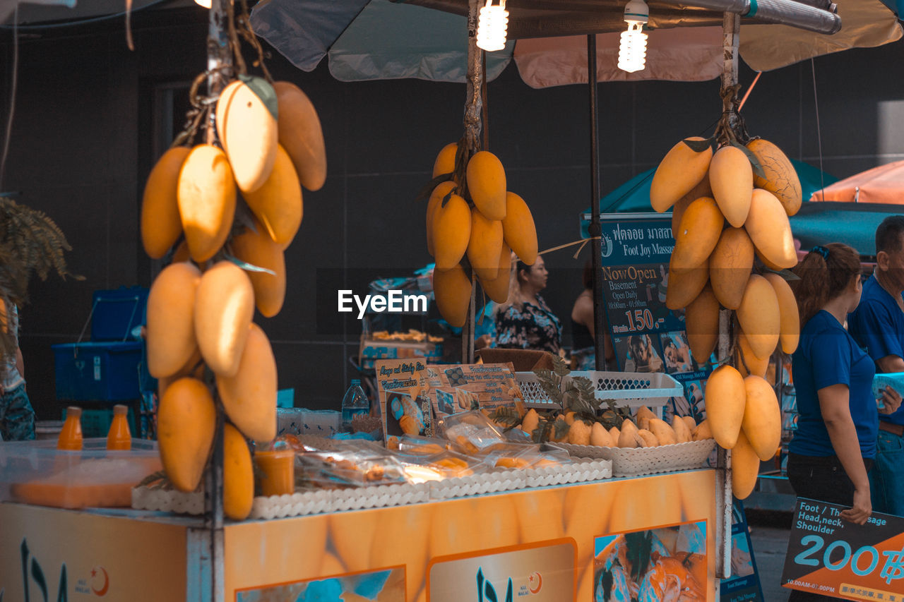 GROUP OF PEOPLE IN MARKET STALL