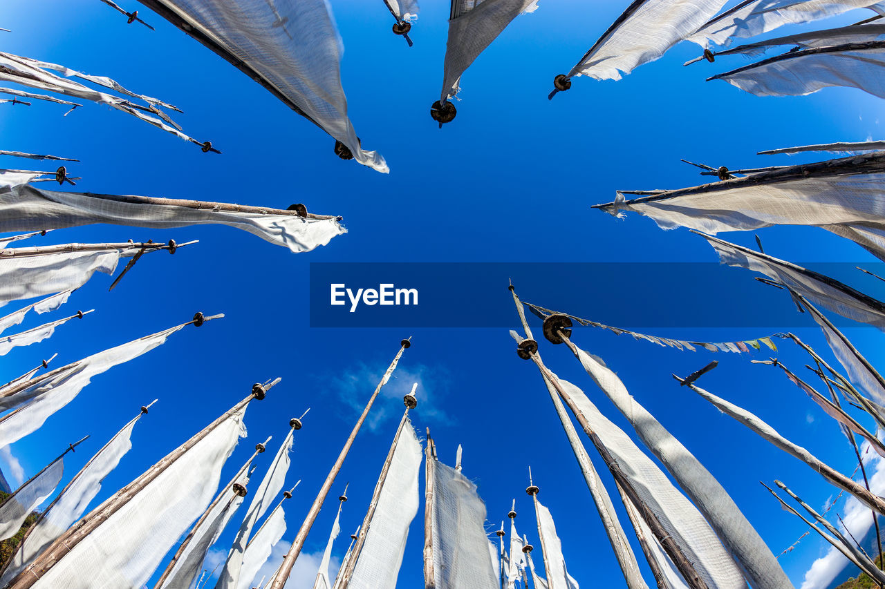 LOW ANGLE VIEW OF CRANES AGAINST SKY