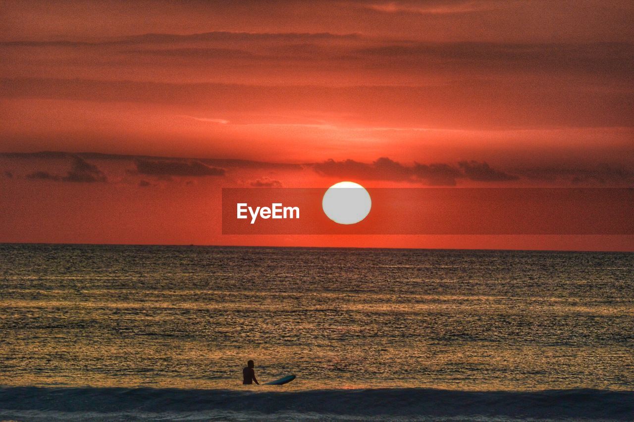 Scenic view of beach against sky during sunset