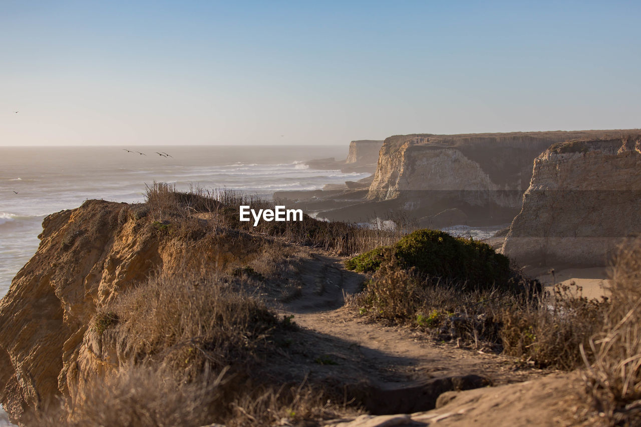 Scenic view of sea against clear sky during sunset