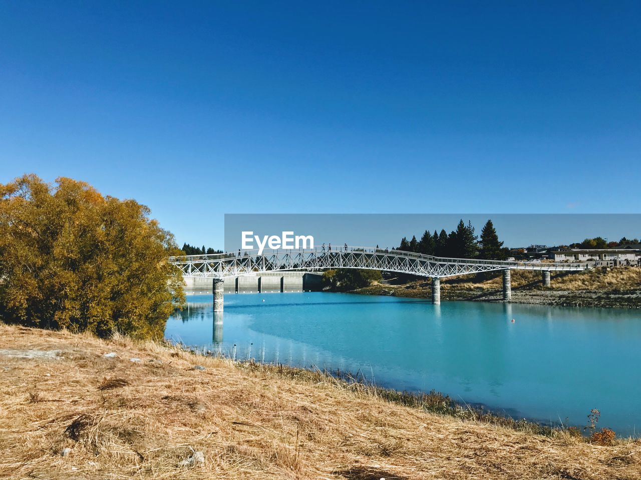 ARCH BRIDGE OVER RIVER AGAINST BLUE SKY