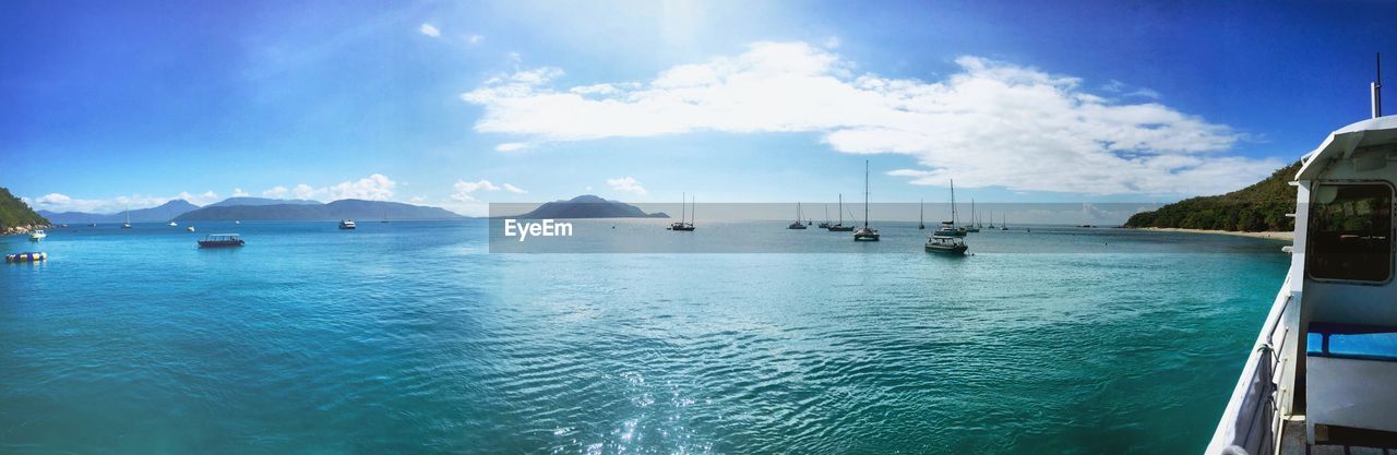 Panoramic view of boats in sea against sky