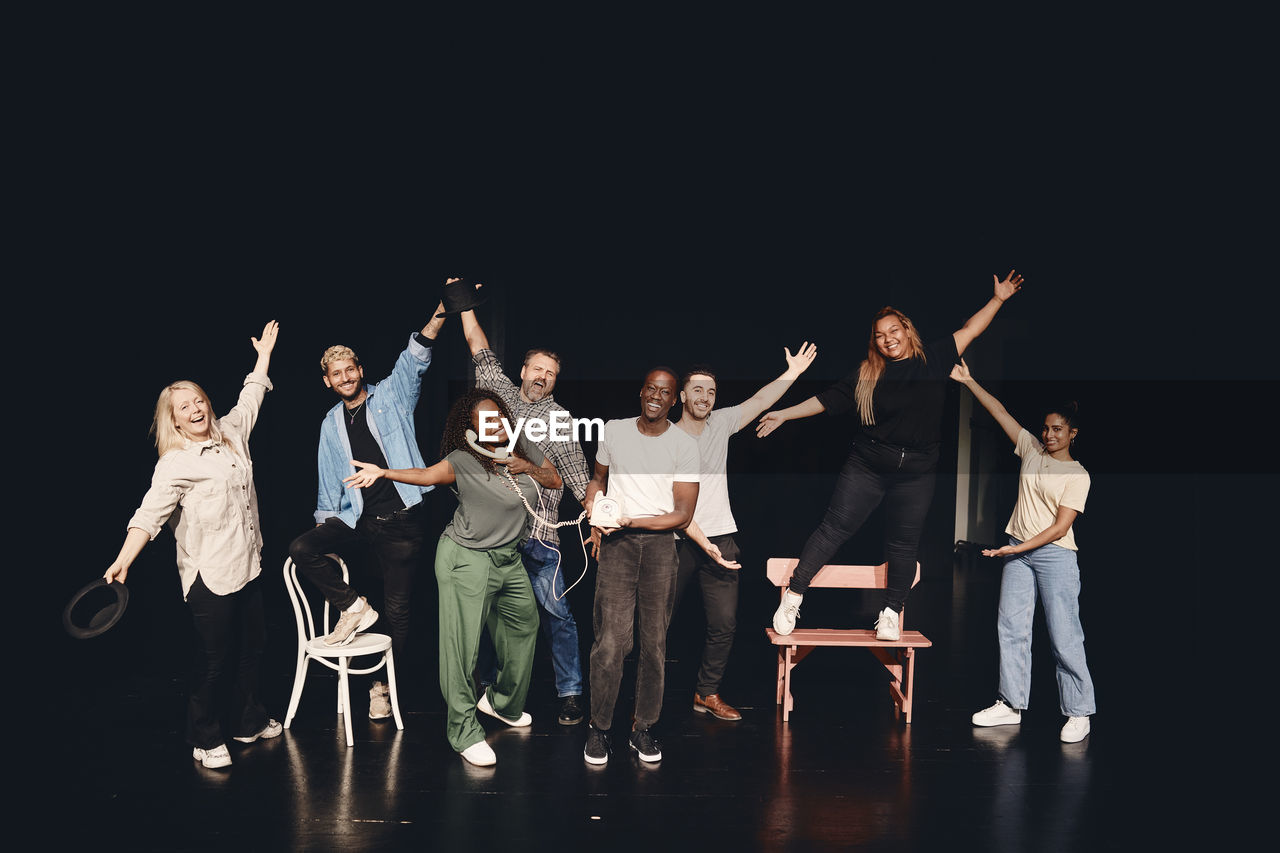 Full length portrait of happy artists together on stage