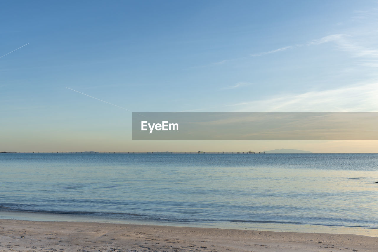 sky, water, sea, body of water, beach, land, scenics - nature, beauty in nature, horizon, tranquility, tranquil scene, ocean, shore, horizon over water, nature, wave, sand, cloud, coast, idyllic, wind wave, no people, sunlight, sunset, blue, outdoors, day, non-urban scene, motion