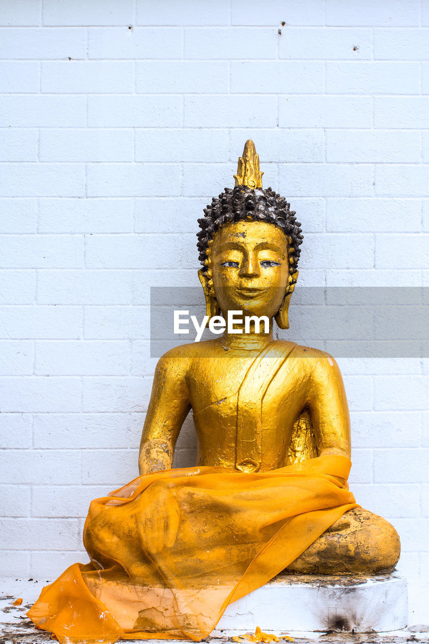 Golden buddha on white background brick block