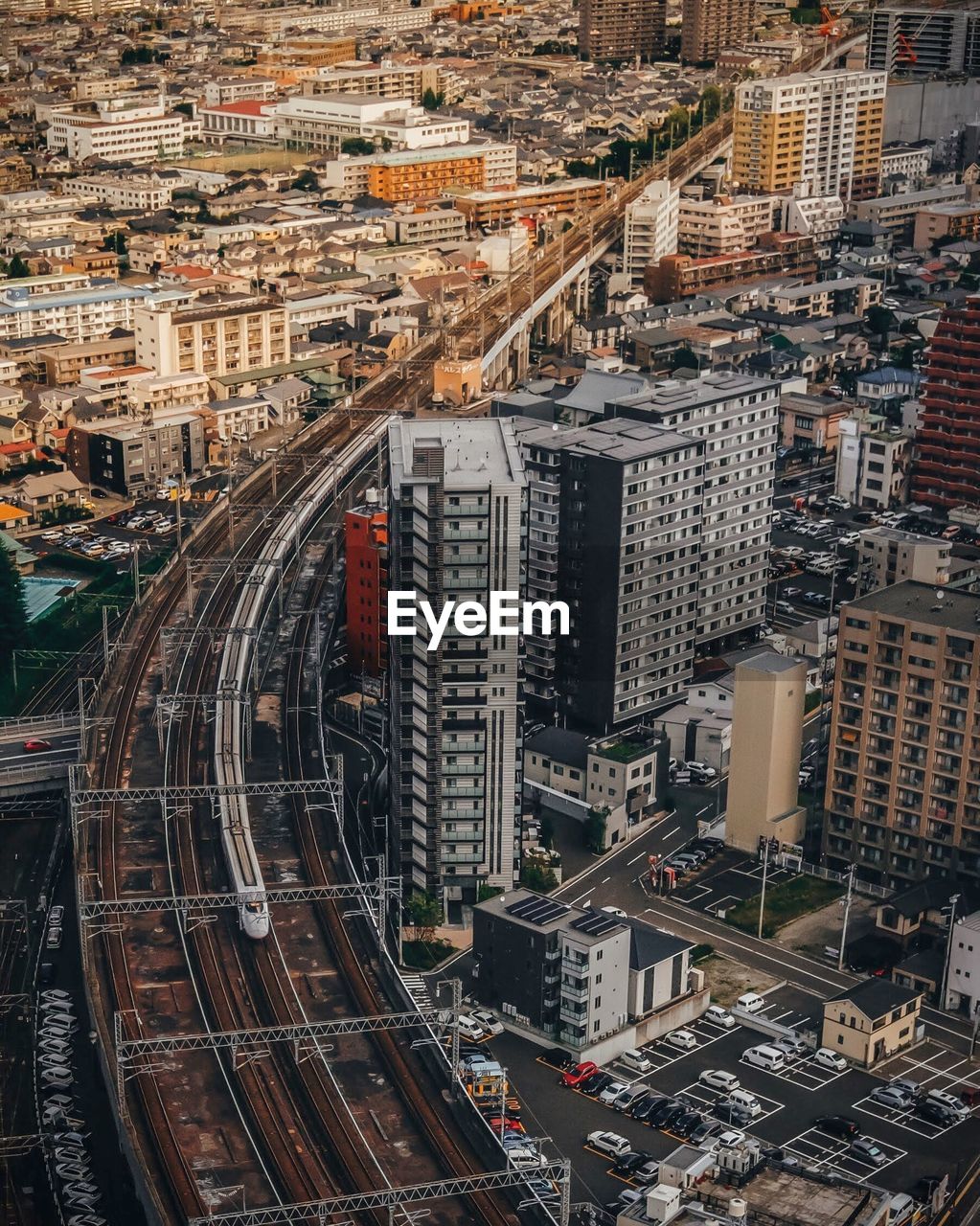 High angle view of railway bridge amidst buildings in city