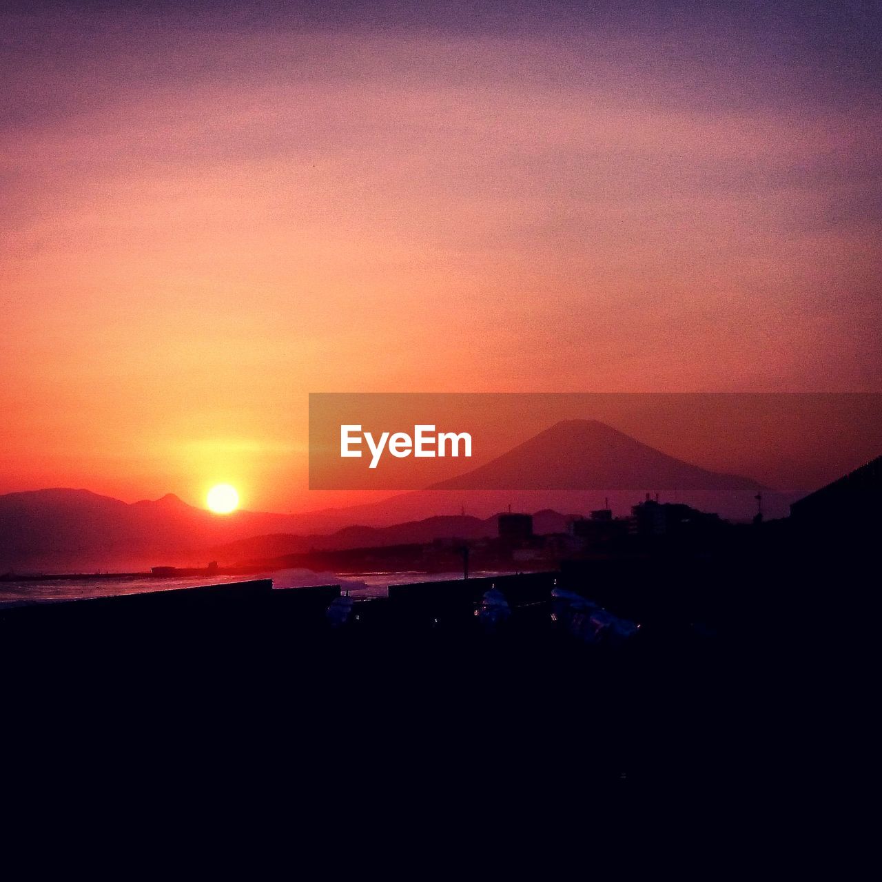 Scenic view of silhouette mountains against sky during sunset