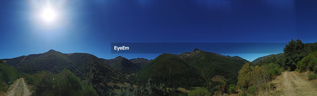 PANORAMIC VIEW OF MOUNTAIN RANGE AGAINST CLEAR BLUE SKY