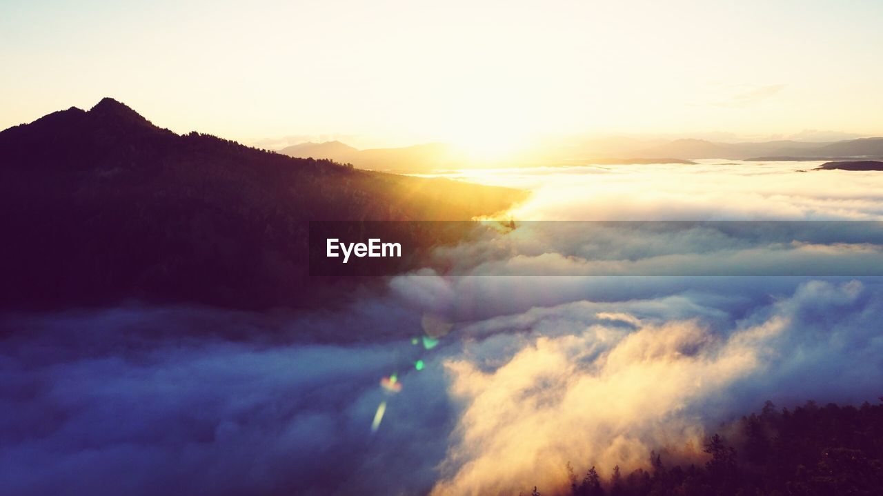 SCENIC VIEW OF MOUNTAINS AGAINST SKY DURING SUNSET