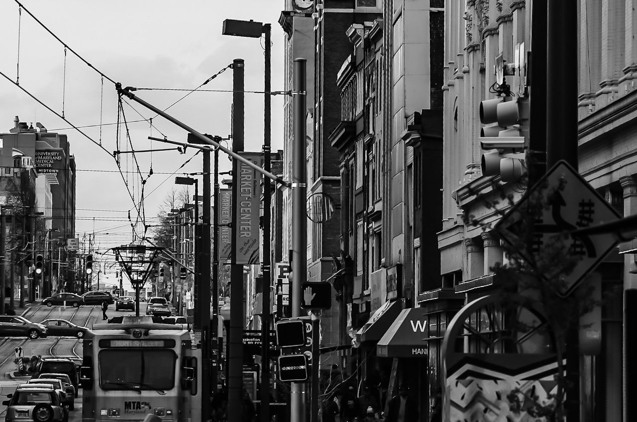 Tram and cars on street in city