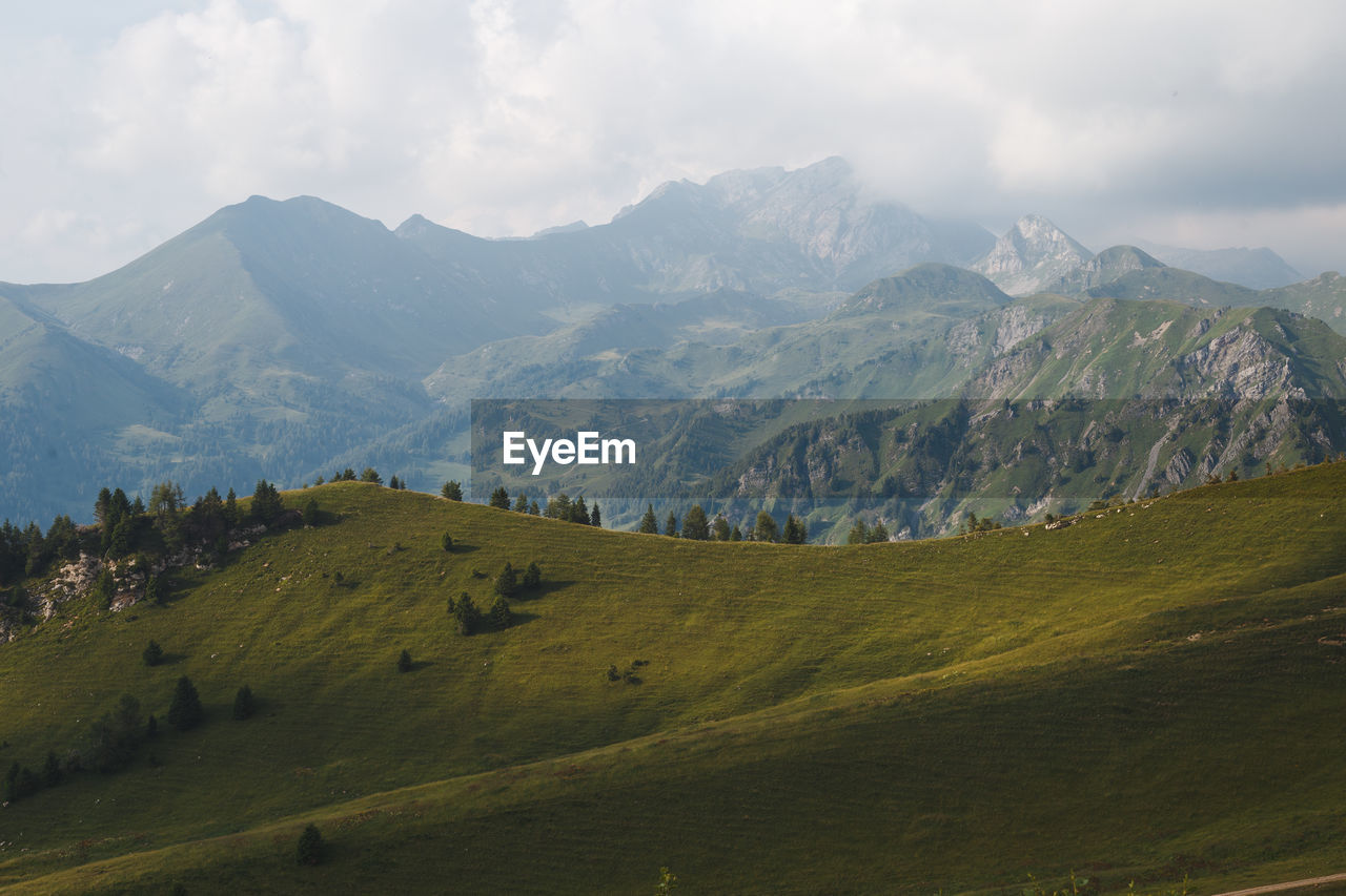 Scenic view of landscape and mountains against sky