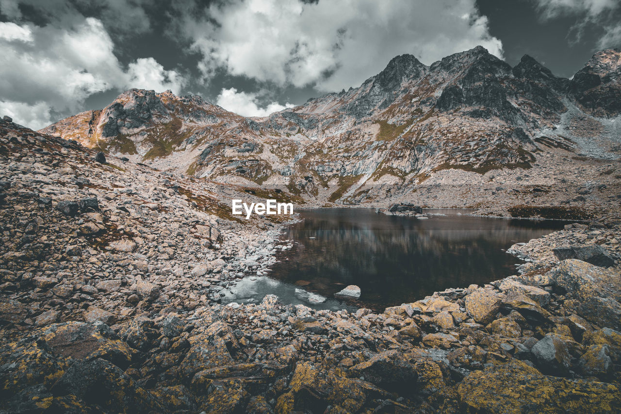 Scenic view of lake and mountains against sky