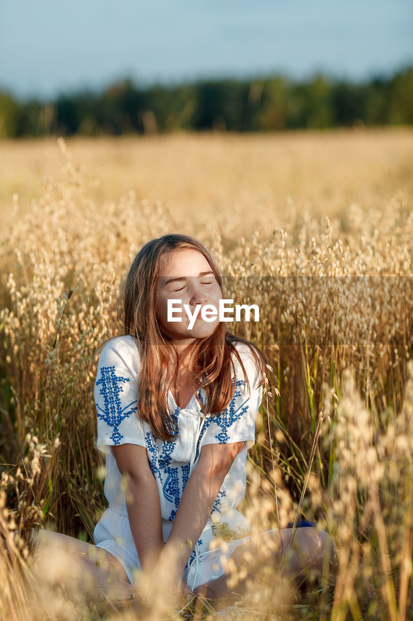 TEENAGE GIRL IN A FIELD