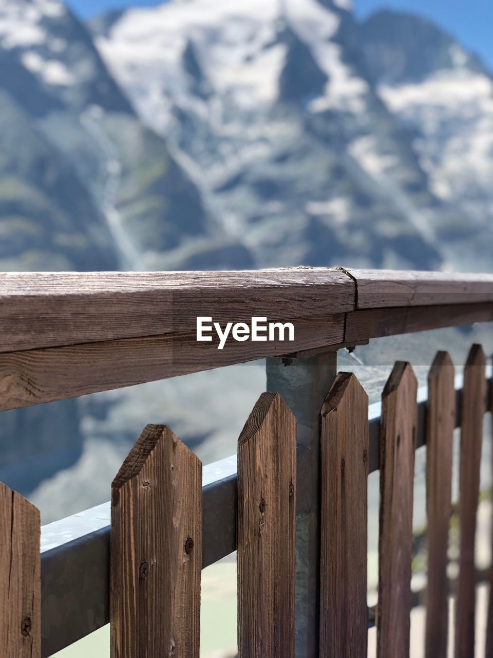 Close-up of fence against mountains