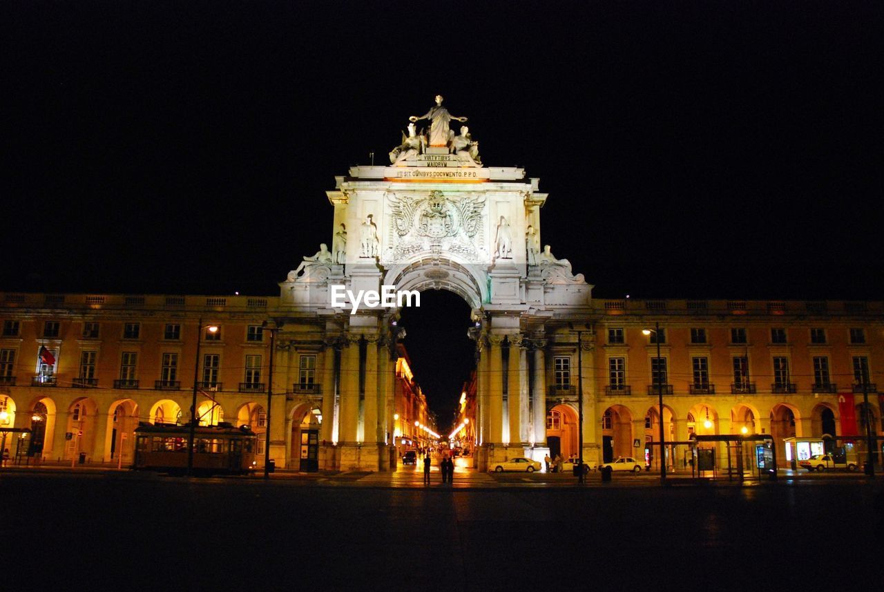 Illuminated building against clear sky at night