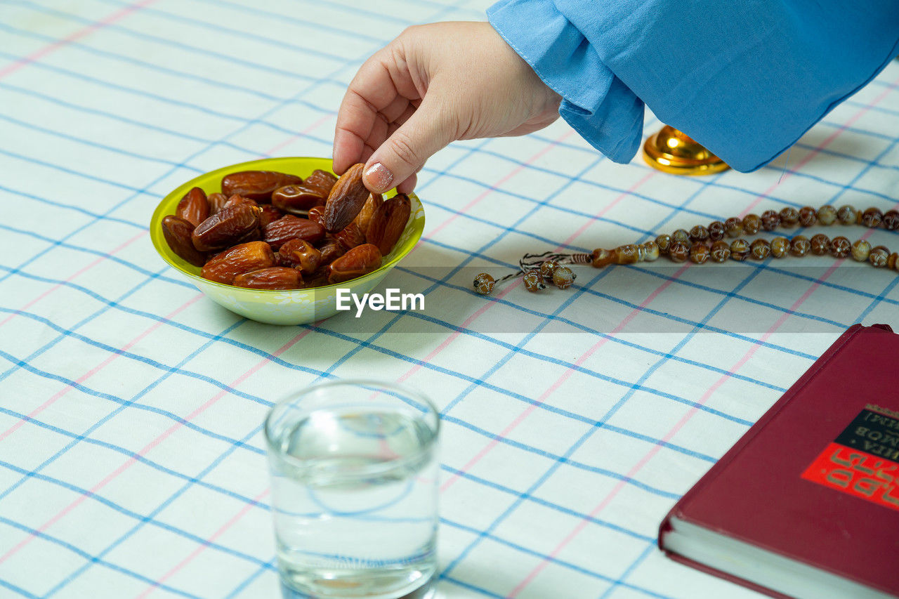 food and drink, food, one person, hand, indoors, adult, healthy eating, holding, wellbeing, table, drink, high angle view, lifestyles, men, refreshment, business, freshness, household equipment