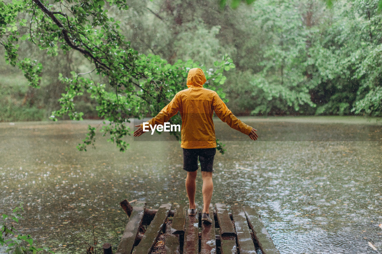 Rear view of boy standing on water