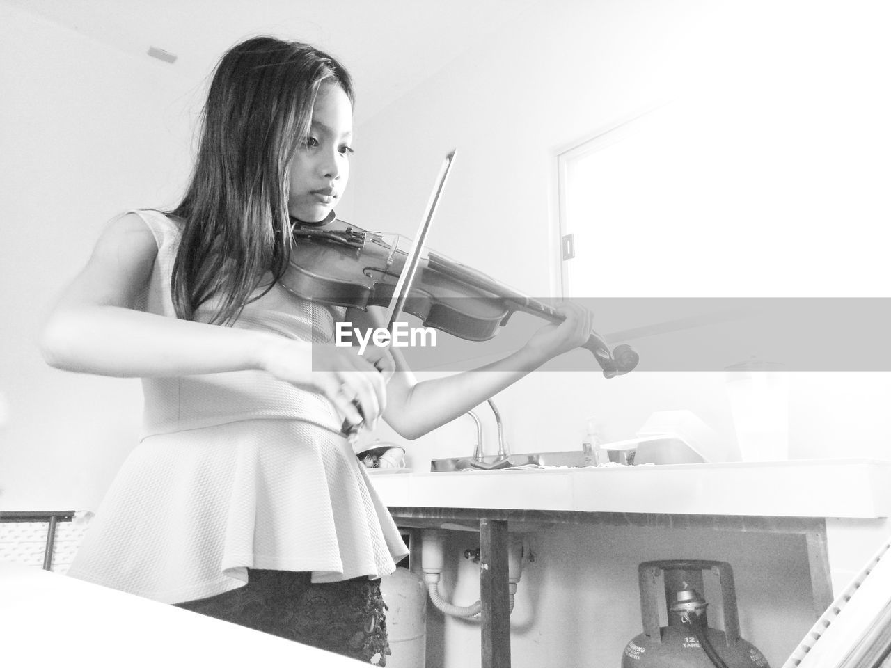 Girl playing violin at home