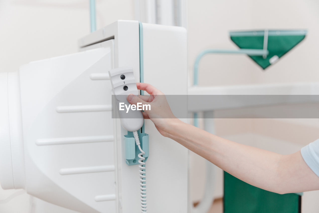 Cropped hand of nurse using medical equipment