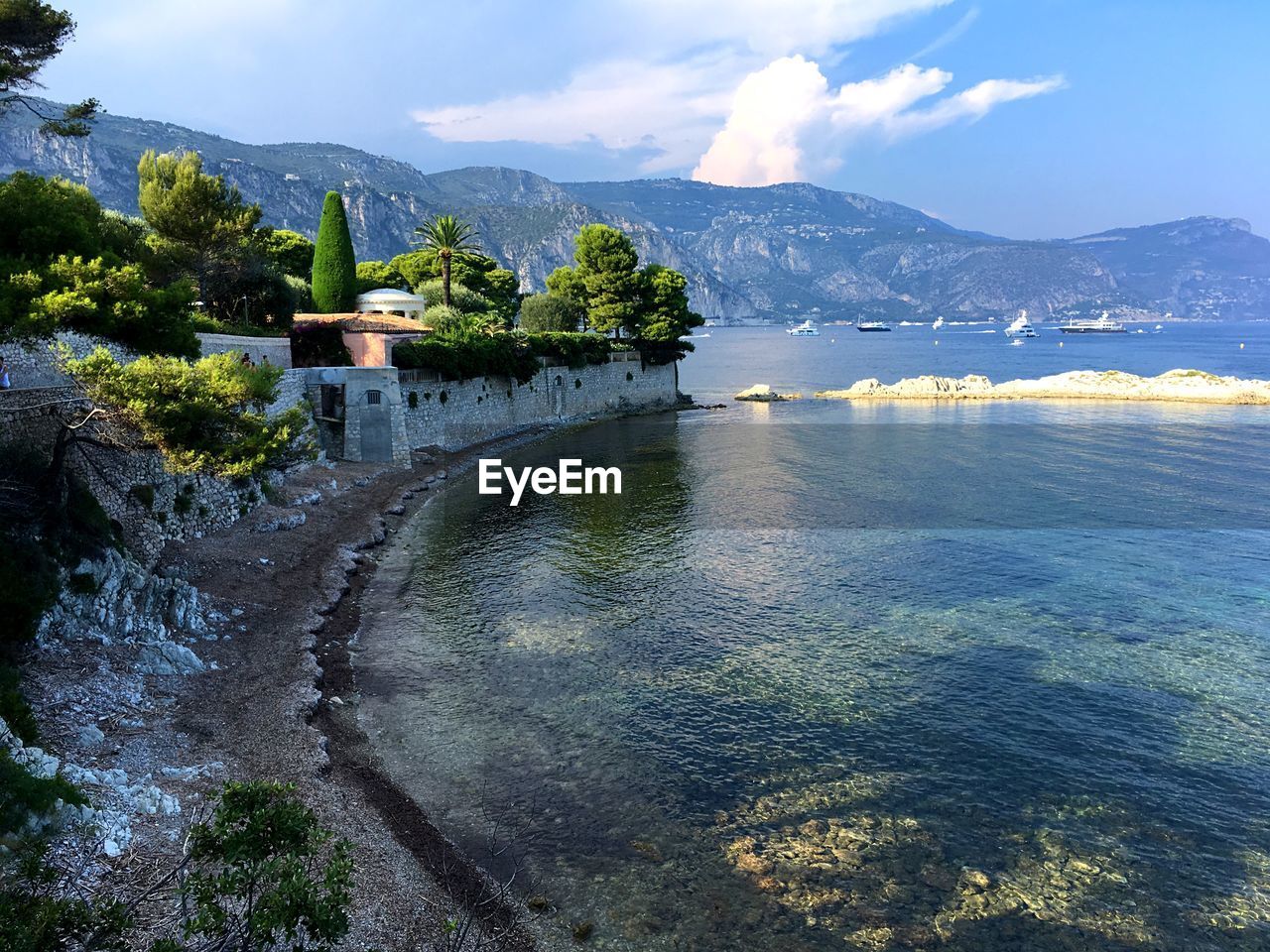 Scenic view of lake by building against sky