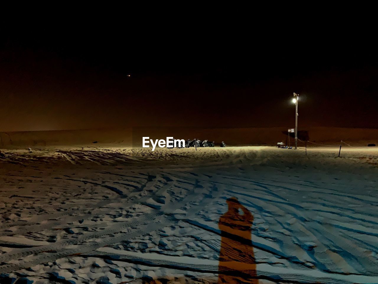 SCENIC VIEW OF SNOW COVERED LAND AT NIGHT