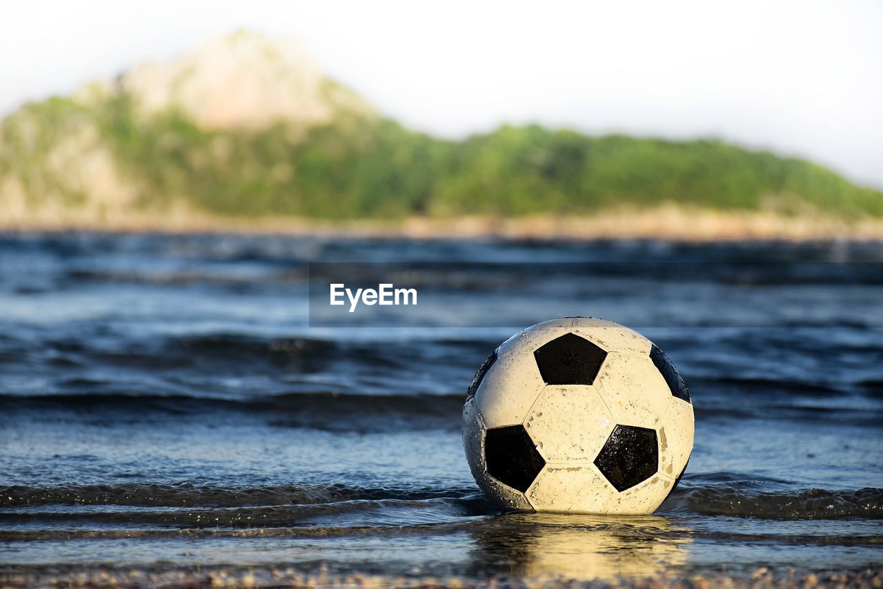 CLOSE-UP OF SOCCER BALL IN THE SEA