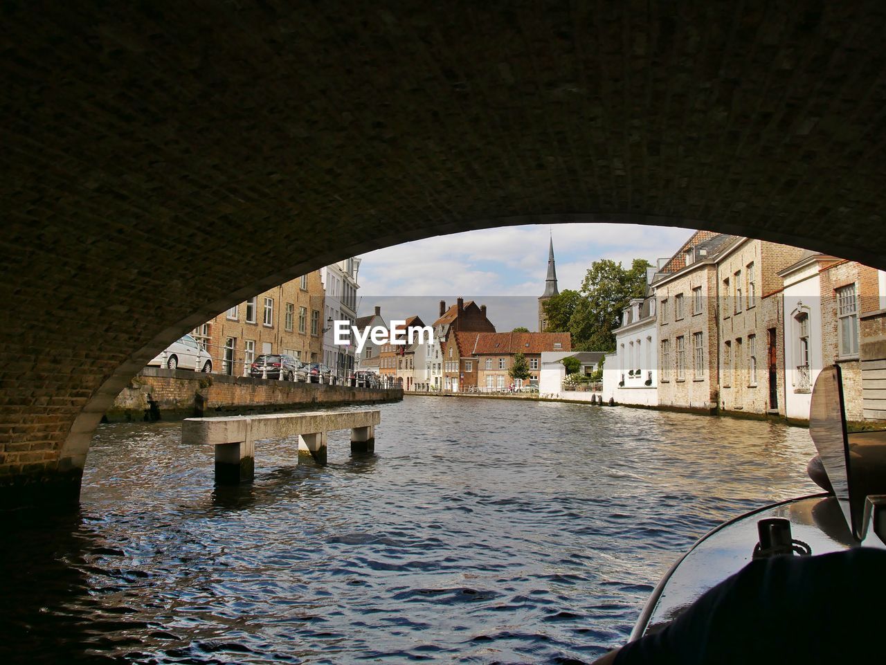 BRIDGE OVER RIVER AGAINST SKY SEEN FROM ARCH