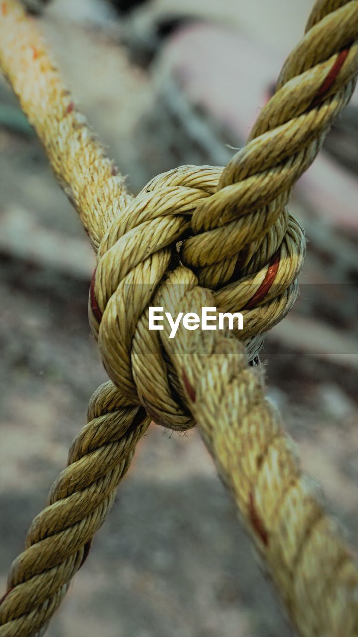 Close-up of rope tied up on metal