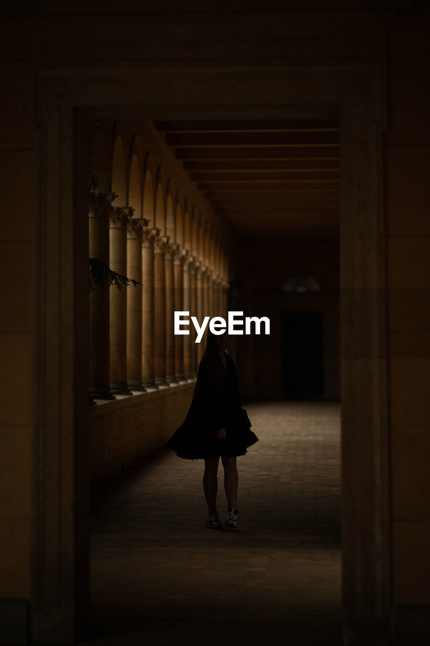 Woman walking in corridor of building