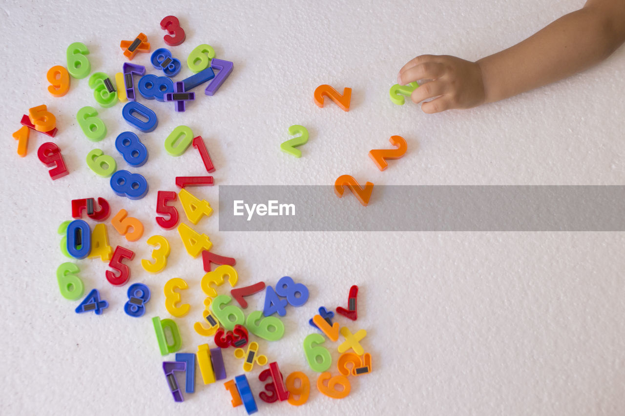 Close-up of baby playing with toys on floor