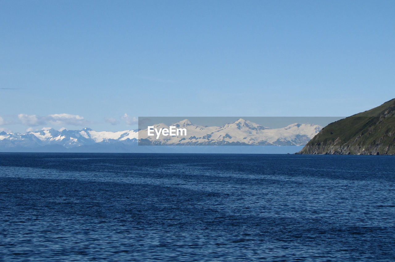 Scenic view of sea against blue sky