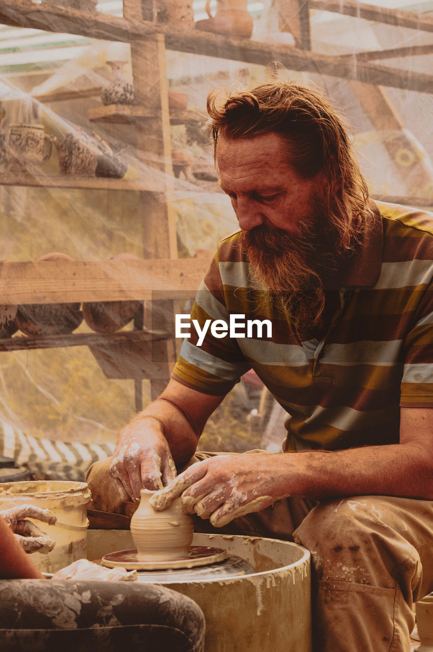 MAN WORKING IN TRADITIONAL CLOTHING