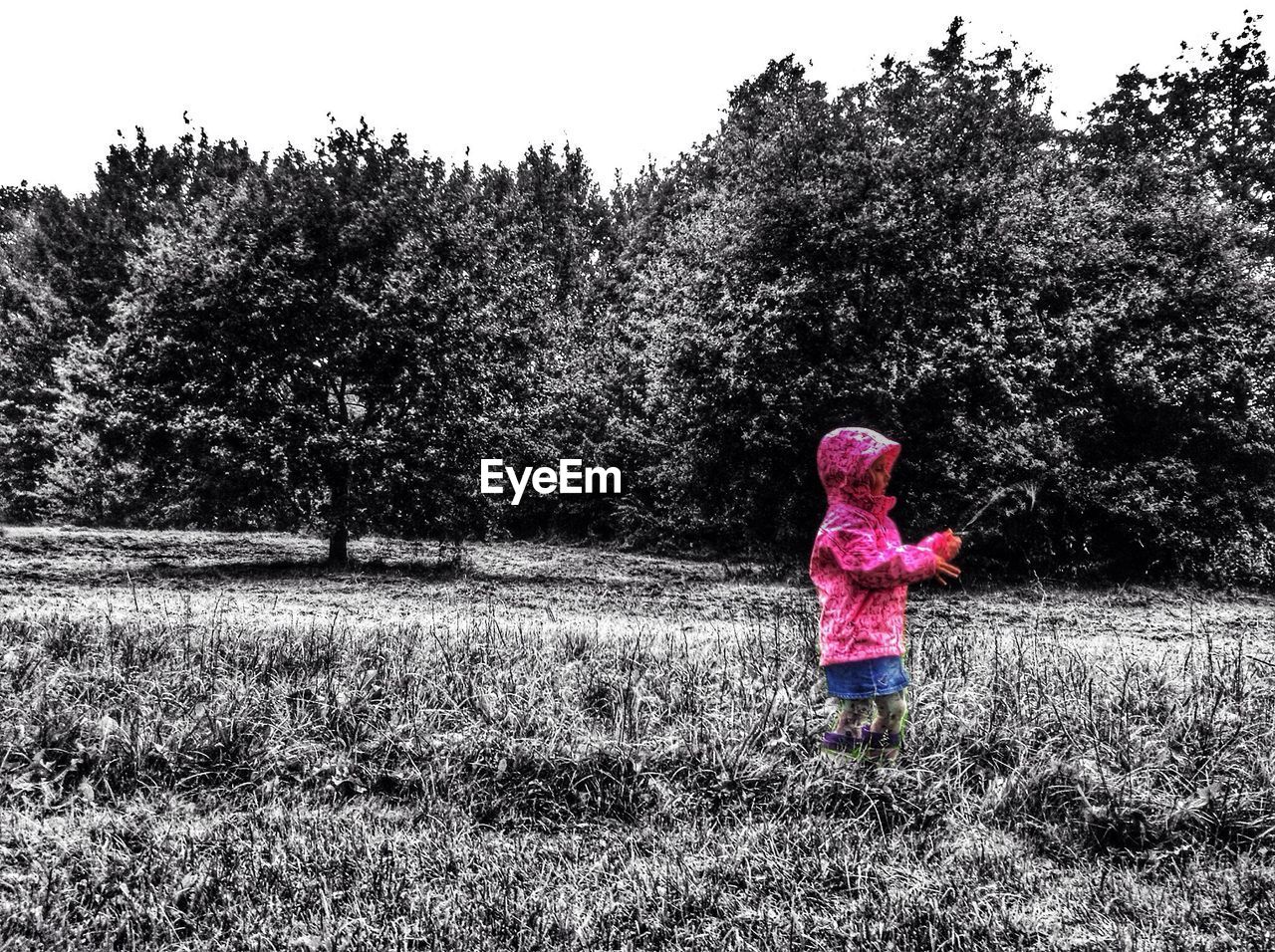 Girl playing on grassy field