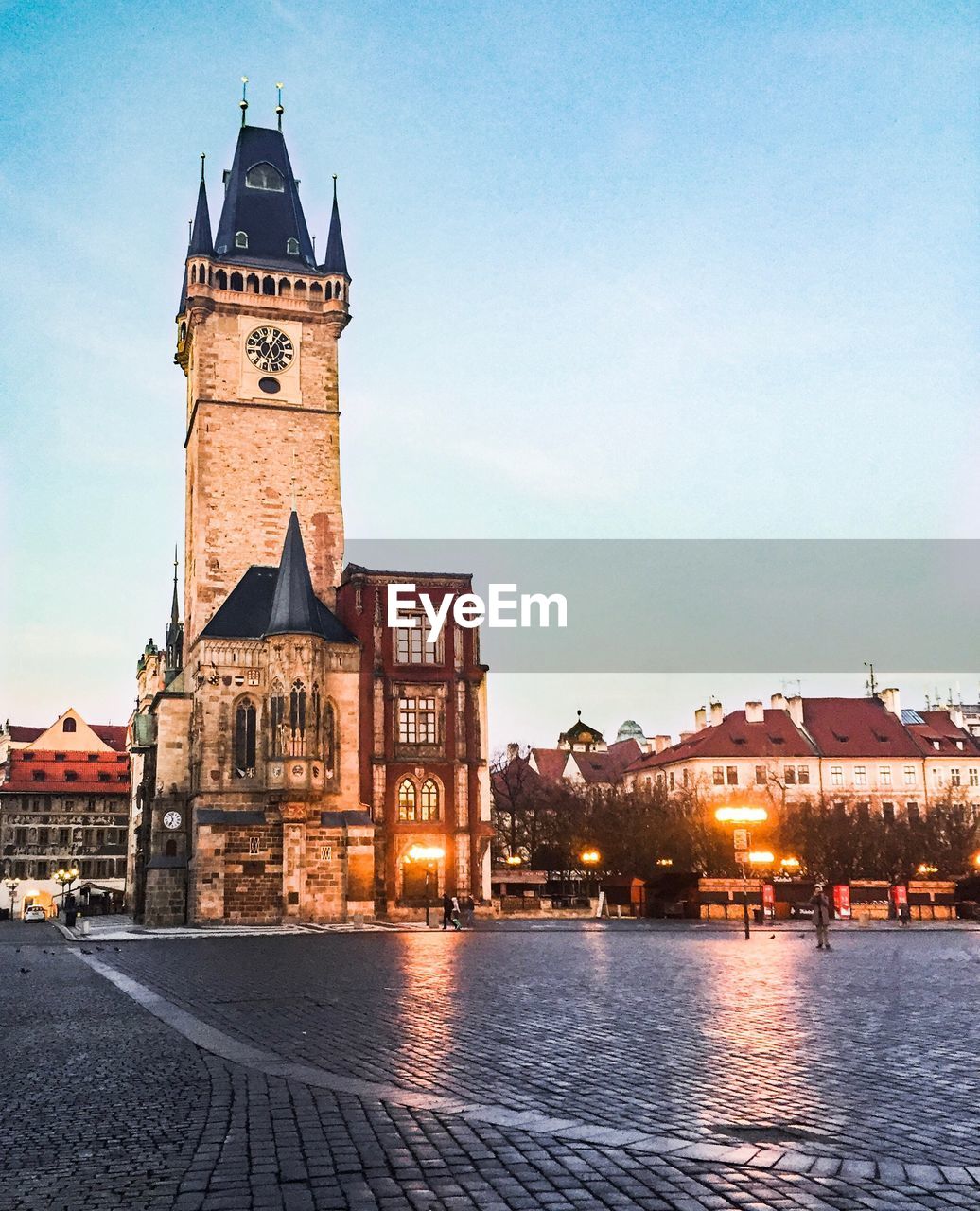 CLOCK TOWER AMIDST BUILDINGS IN CITY