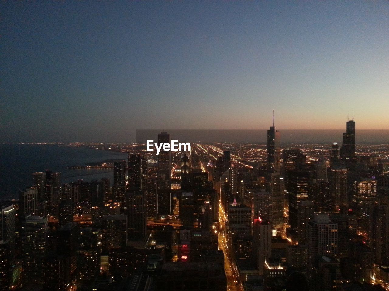 HIGH ANGLE VIEW OF CITYSCAPE AT NIGHT