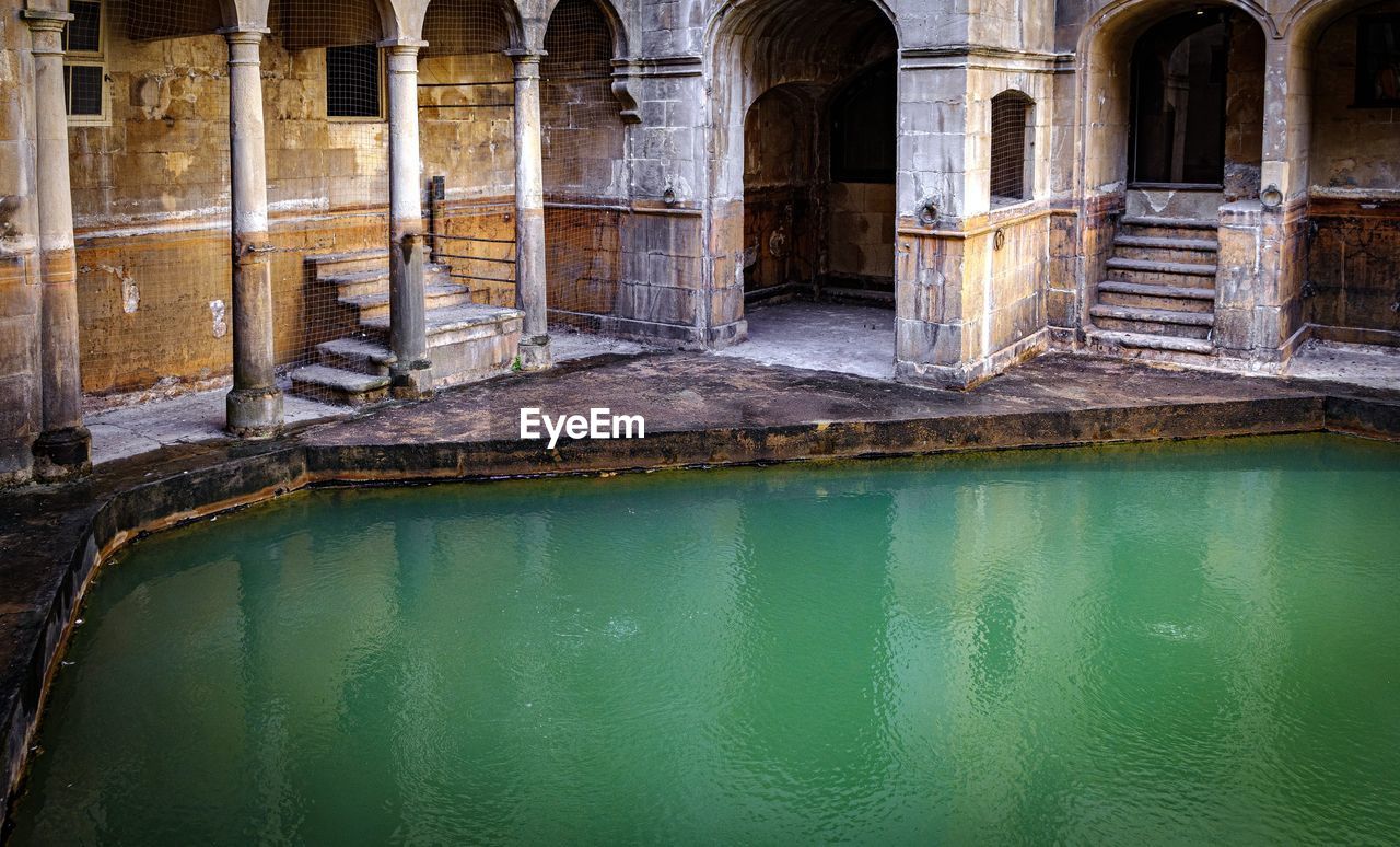 Reflection of old building in swimming pool