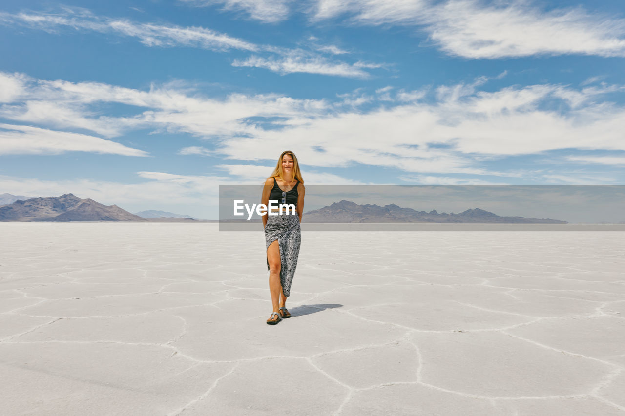 Young woman exploring bonneville salt flats during a summer road trip.