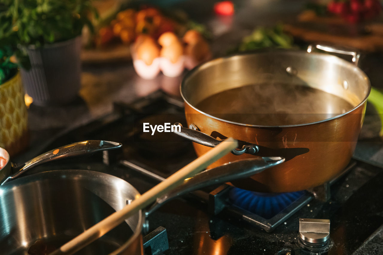 Pot of boiling water on the cooker in the kitchen. preparing food in the kitchen for lunch or dinne