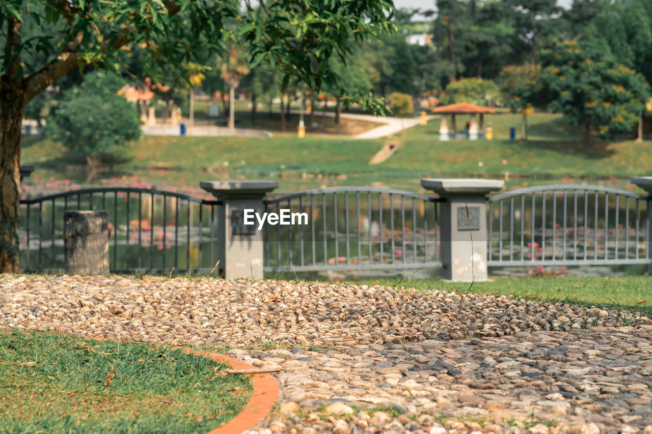 Concrete fence near the lake at the park.