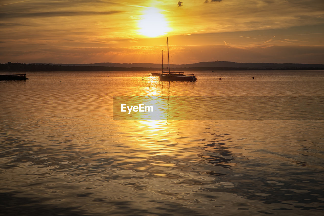 SCENIC VIEW OF SEA AGAINST ORANGE SKY