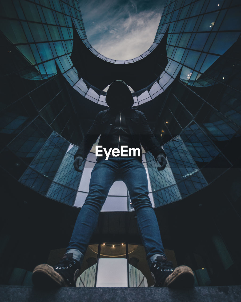 Low angle view of man standing against building in city