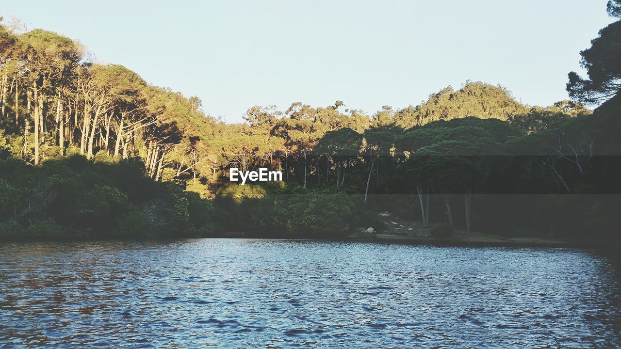 SCENIC VIEW OF LAKE AGAINST SKY AT SUNSET